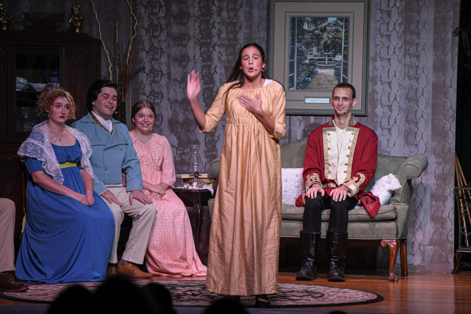 A woman in a yellow dress is on stage