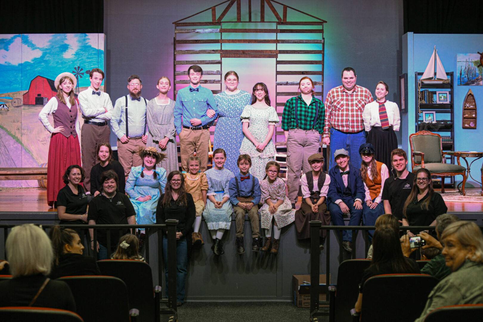 A group of people standing on top of a stage.